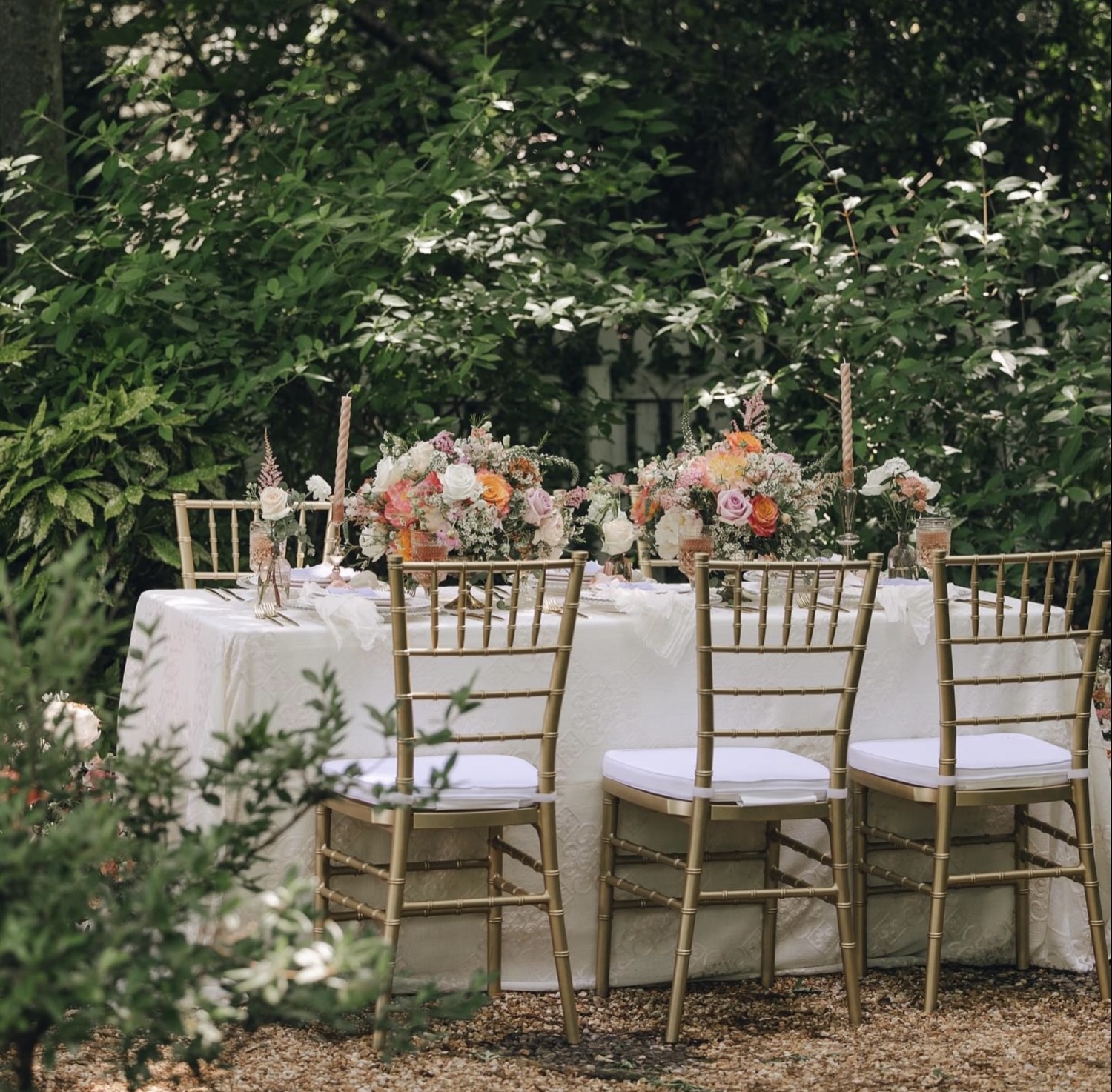 Elegant garden reception table with gold chiavari chairs